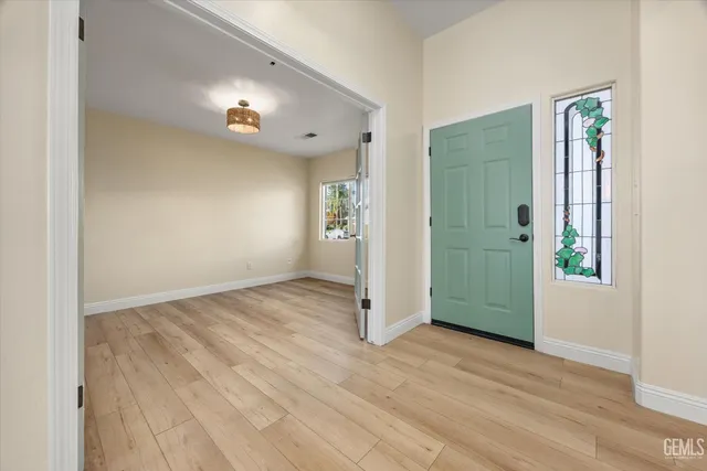 a view of an empty room and wooden floor