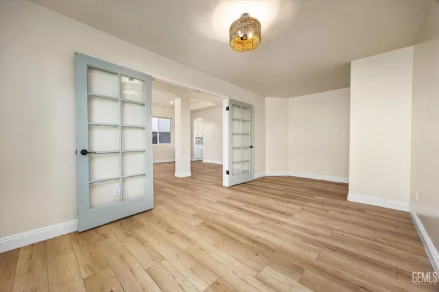 a kitchen with white cabinets stove and stainless steel appliances