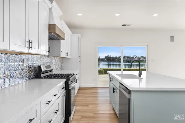 a living room with furniture kitchen view and a flat screen tv