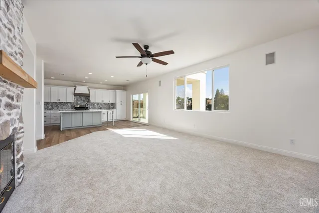 a living room with furniture and a ceiling fan