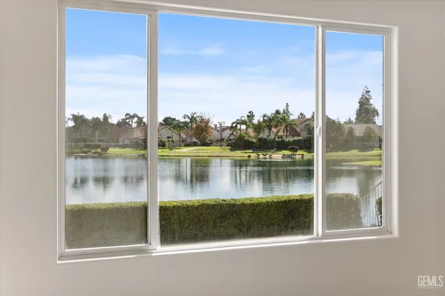 a spacious bedroom with a large bed and a chandelier