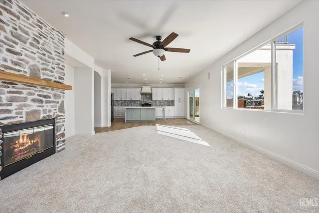 a spacious bedroom with a bed and a painting on the wall