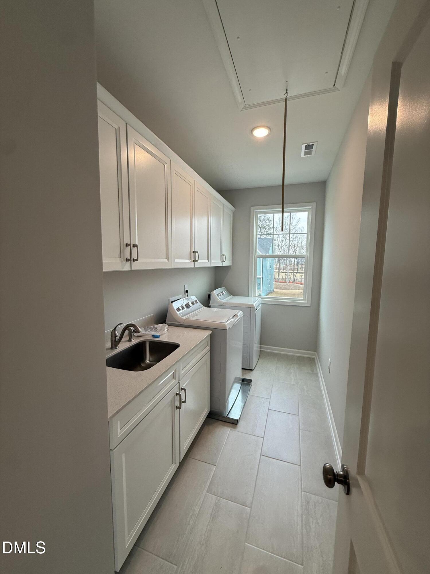 2416 Picual Way Apex, NC 27502 - Photo 11 of 17 a kitchen with a sink a stove and cabinets