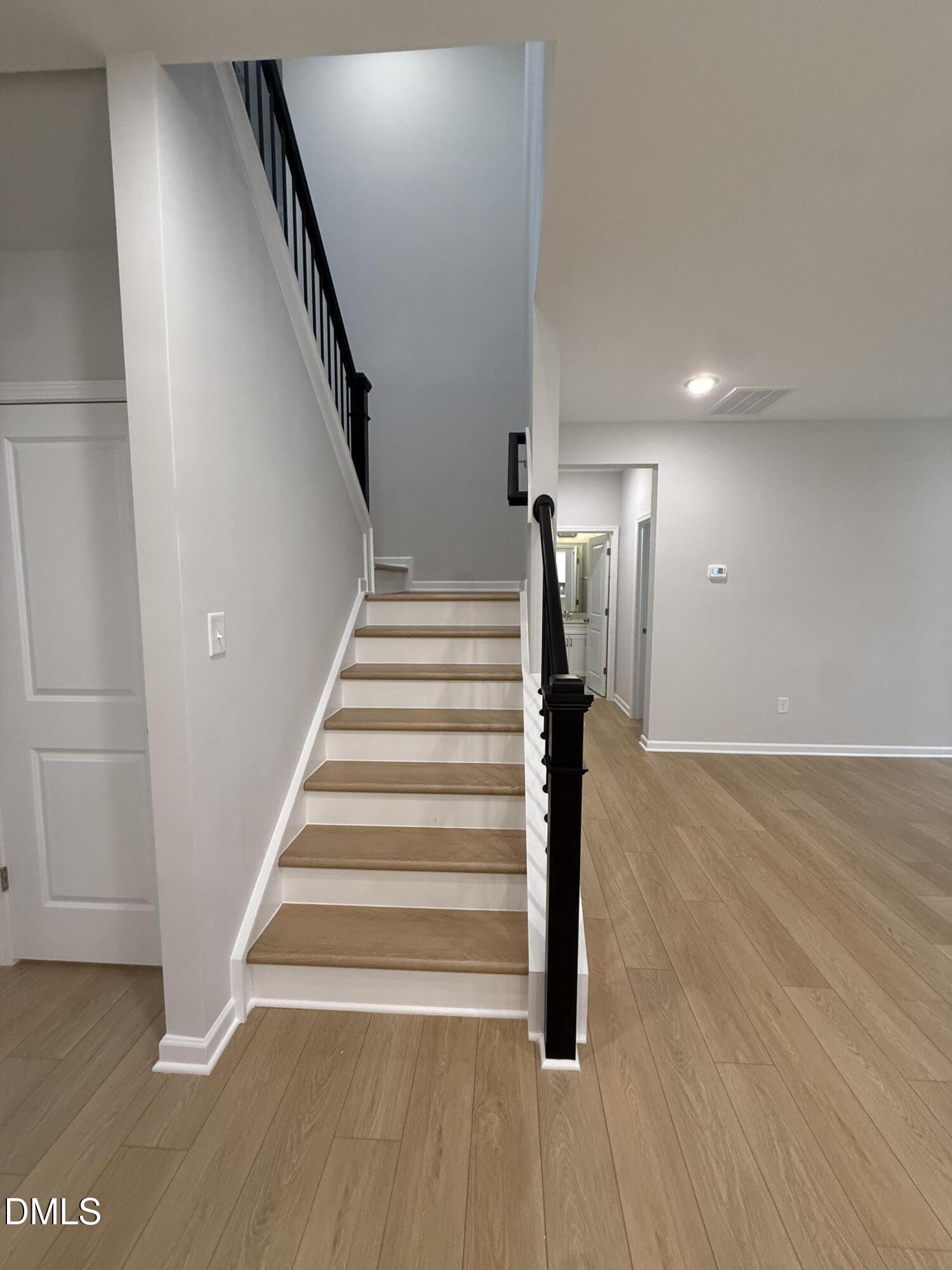 2416 Picual Way Apex, NC 27502 - Photo 3 of 17 a view of entryway and hall with wooden floor