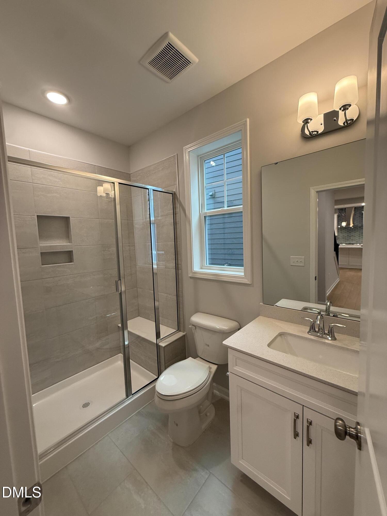 2416 Picual Way Apex, NC 27502 - Photo 5 of 17 a bathroom with a sink a toilet and shower