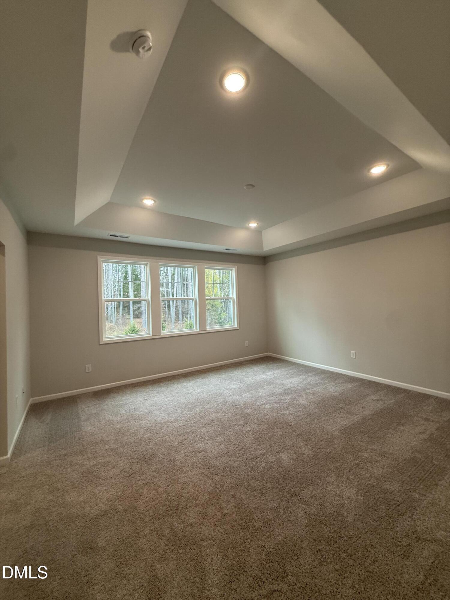 2416 Picual Way Apex, NC 27502 - Photo 8 of 17 an empty room with a empty space and windows