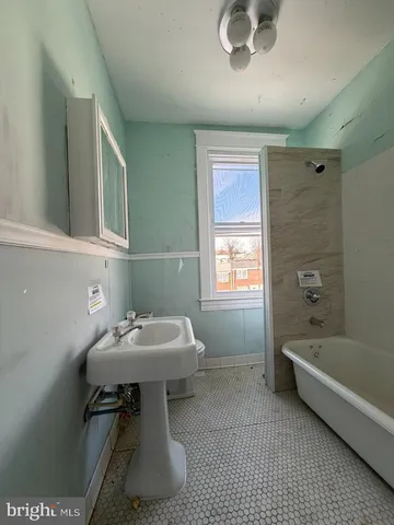 a bathroom with a sink toilet and bathtub