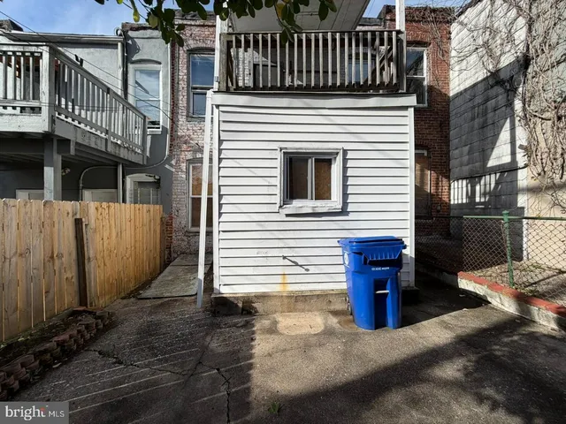a view of a house with wooden fence