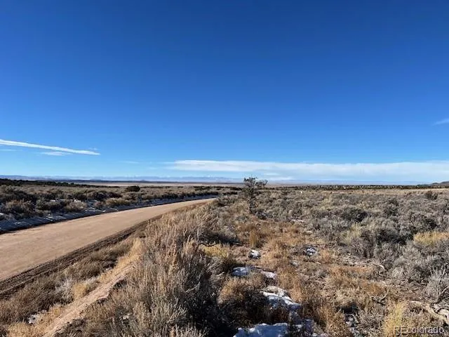 a view of a large building with mountains in the background