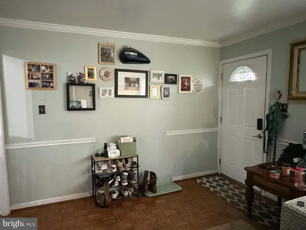 a room with painting on the wall and a window