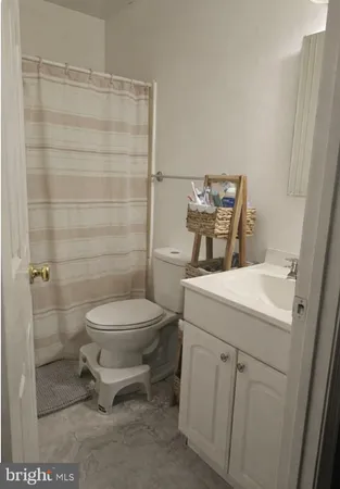 a bathroom with a toilet sink and shower