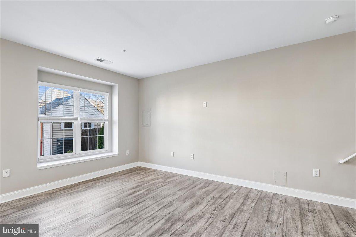 8737 Autumn Ridge Court Odenton, MD 21113 - Photo 12 of 46 a view of empty room with wooden floor and fan