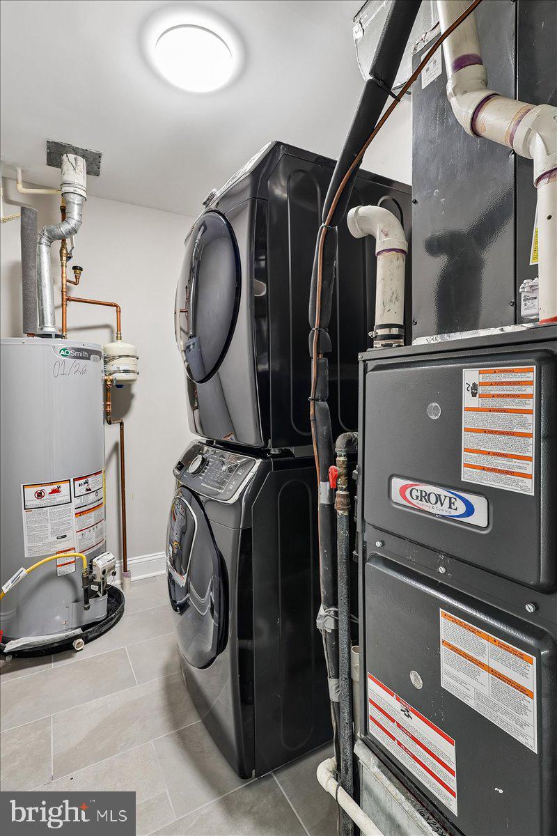 8737 Autumn Ridge Court Odenton, MD 21113 - Photo 17 of 46 a utility room with dryer washer and a view of living room