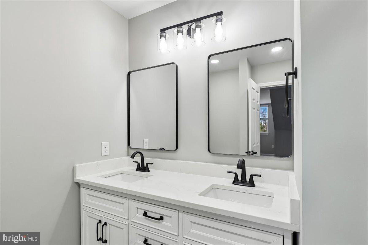 8737 Autumn Ridge Court Odenton, MD 21113 - Photo 22 of 46 a bathroom with a sink and a mirror