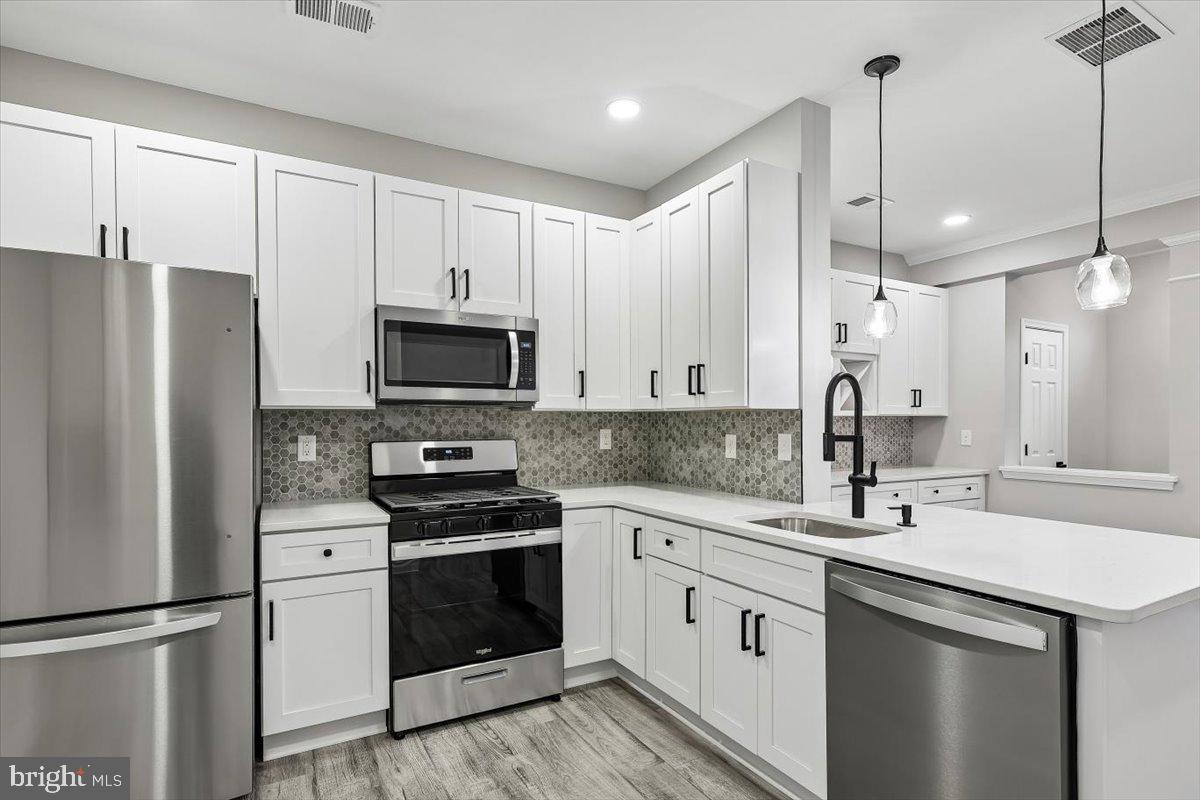 8737 Autumn Ridge Court Odenton, MD 21113 - Photo 4 of 46 a kitchen with a sink stainless steel appliances and cabinets