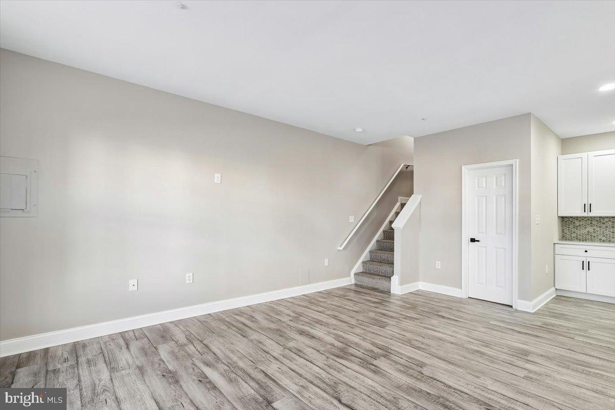 8737 Autumn Ridge Court Odenton, MD 21113 - Photo 10 of 46 a view of an empty room with wooden floor and hallway