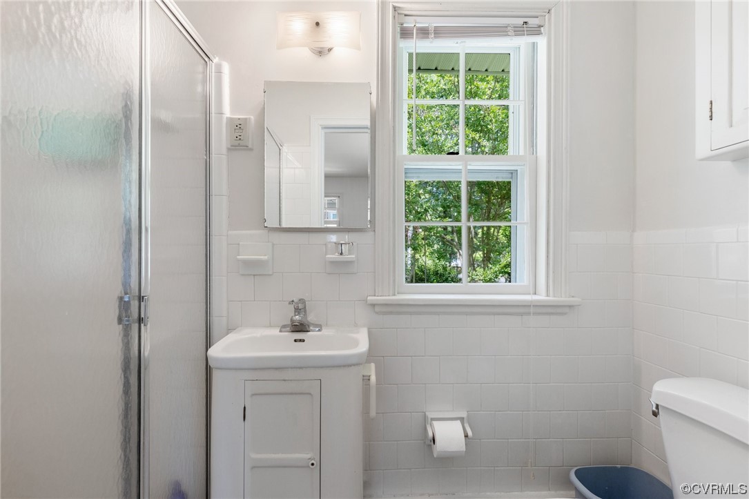 9505 Newhall Road Henrico, VA 23229 - Photo 22 of 33 a bathroom with a sink a toilet and a window