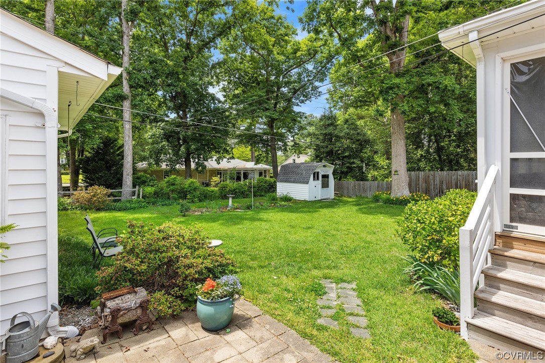 9505 Newhall Road Henrico, VA 23229 - Photo 30 of 33 a view of a house with backyard sitting area and garden