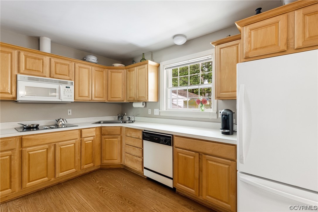 9505 Newhall Road Henrico, VA 23229 - Photo 7 of 33 a kitchen with stainless steel appliances granite countertop a sink and cabinets with wooden floor