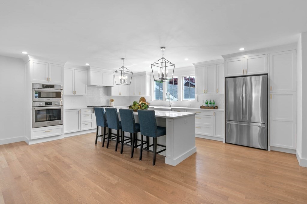 47 Glendale Road Marblehead, MA 01945 - Photo 10 of 33 a kitchen with stainless steel appliances a dining table chairs and wooden floor