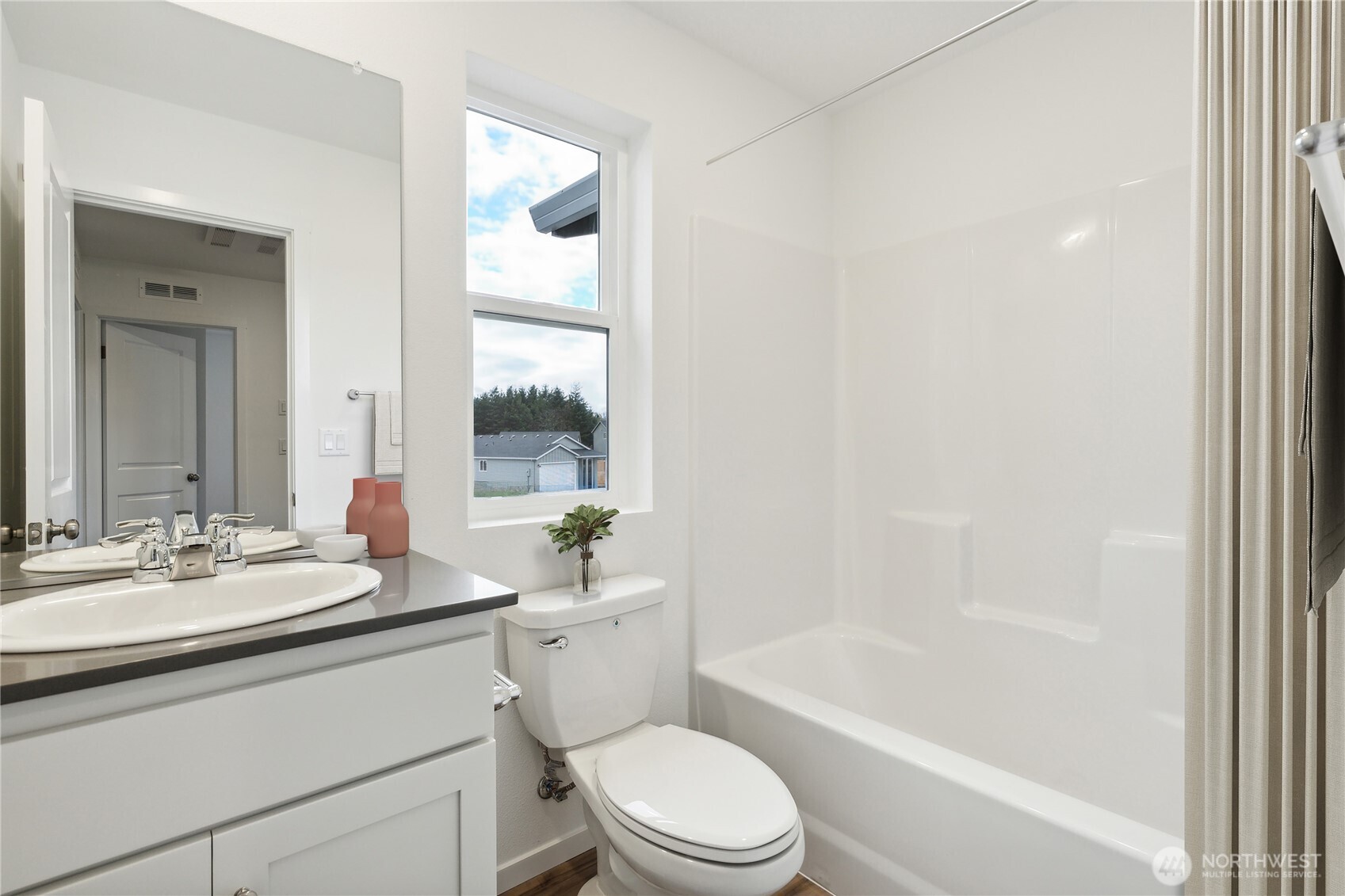 2039 Henderson Way Longview, WA 98632 - Photo 26 of 40 a bathroom with a bathtub shower sink vanity mirror and toilet