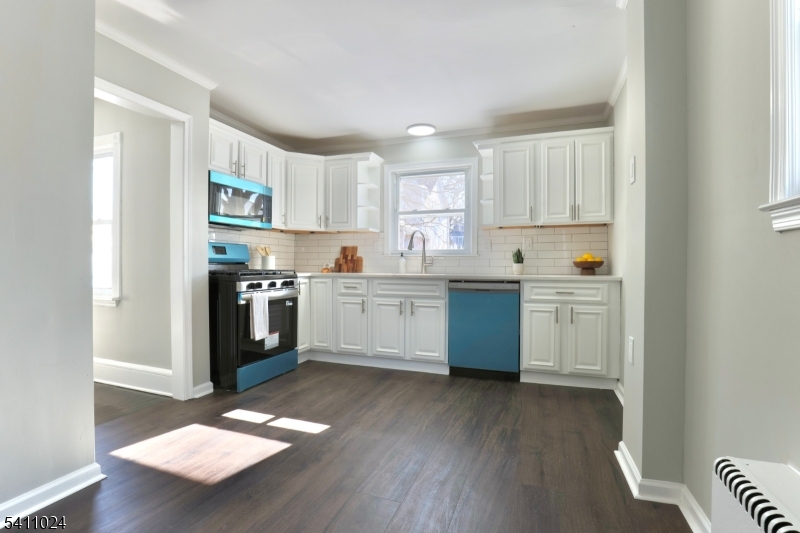 401 Burroughs Terrace Union, NJ 07083 - Photo 17 of 36 a kitchen with a sink cabinets and wooden floor