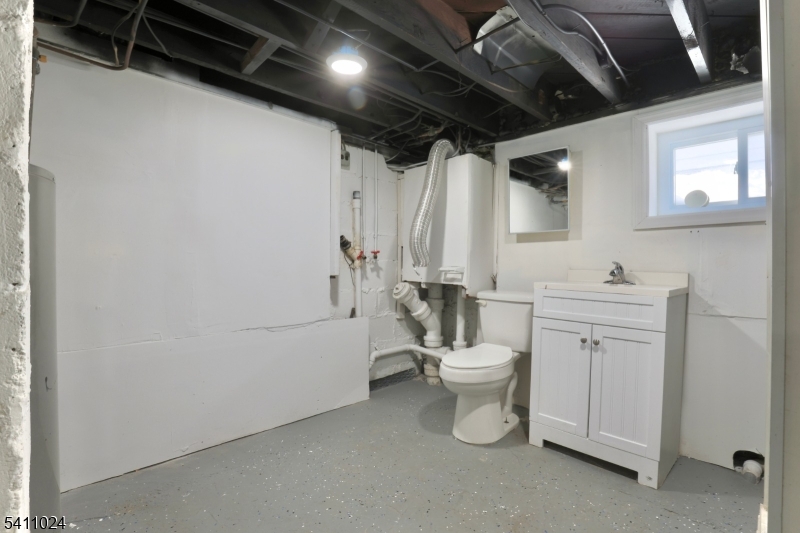 401 Burroughs Terrace Union, NJ 07083 - Photo 28 of 36 a bathroom with a toilet sink and mirror