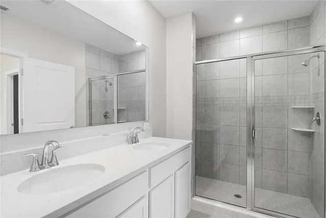 a bathroom with a shower sink and mirror
