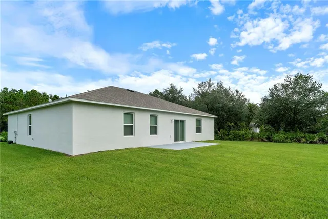 a backyard of a house with lots of green space
