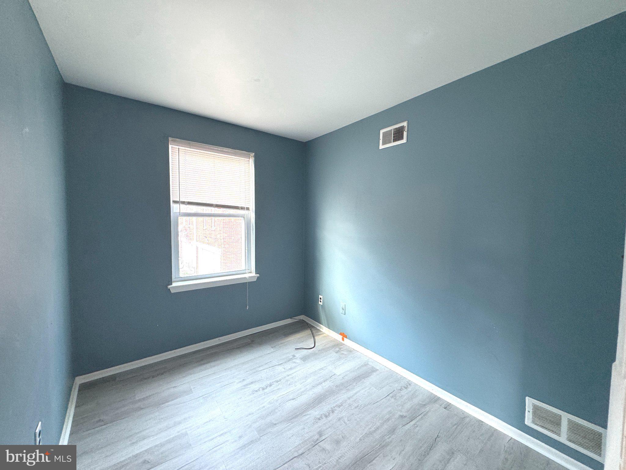 12044 Abby Road, Unit 1 Philadelphia, PA 19154 - Photo 8 of 10 an empty room with wooden floor and windows