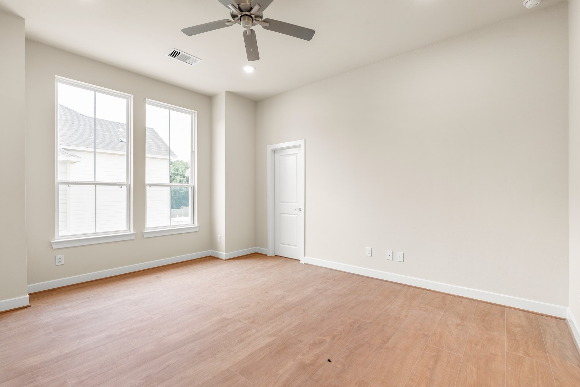 6521 Rena Street Houston, TX 77092 - Photo 12 of 24 Versatile bedroom layout — bright double window setup, clean interior trim, pre-wired media connections, and warm wood-look floors.
