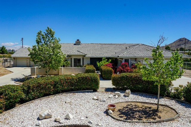 16038 Venango Road Apple Valley, CA 92307 - Photo 1 of 1 a front view of a house with a yard