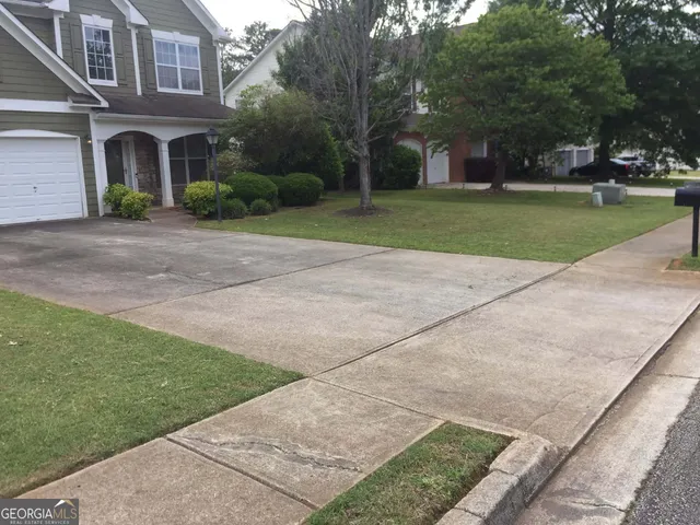 a front view of a building with trees