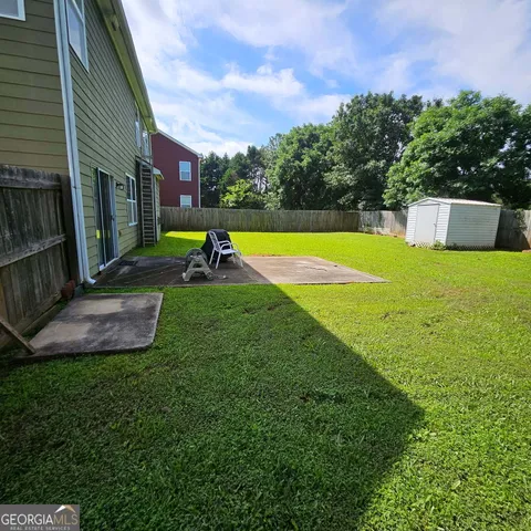 a view of a backyard with swimming pool