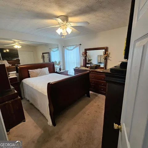 a bedroom with a bed and a mirror