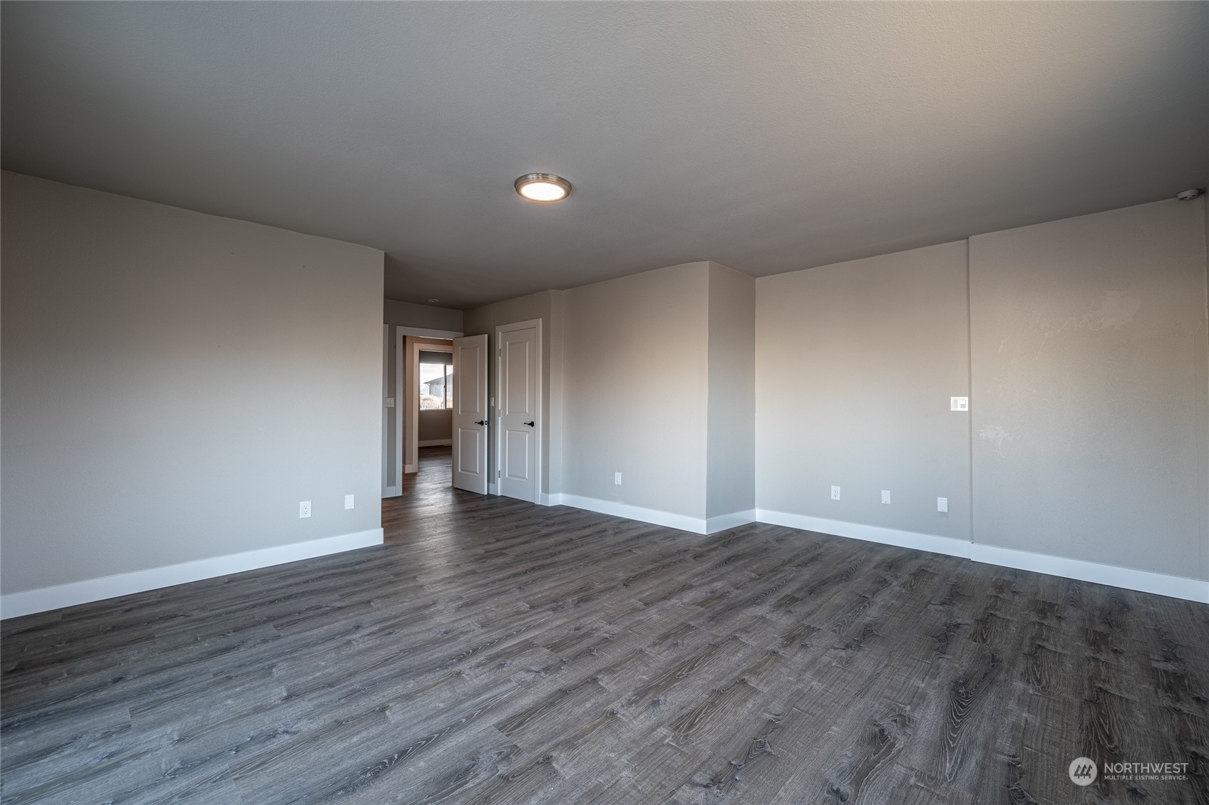 3125 Conarty Road Malaga, WA 98828 - Photo 19 of 37 a view of an empty room with wooden floor and window