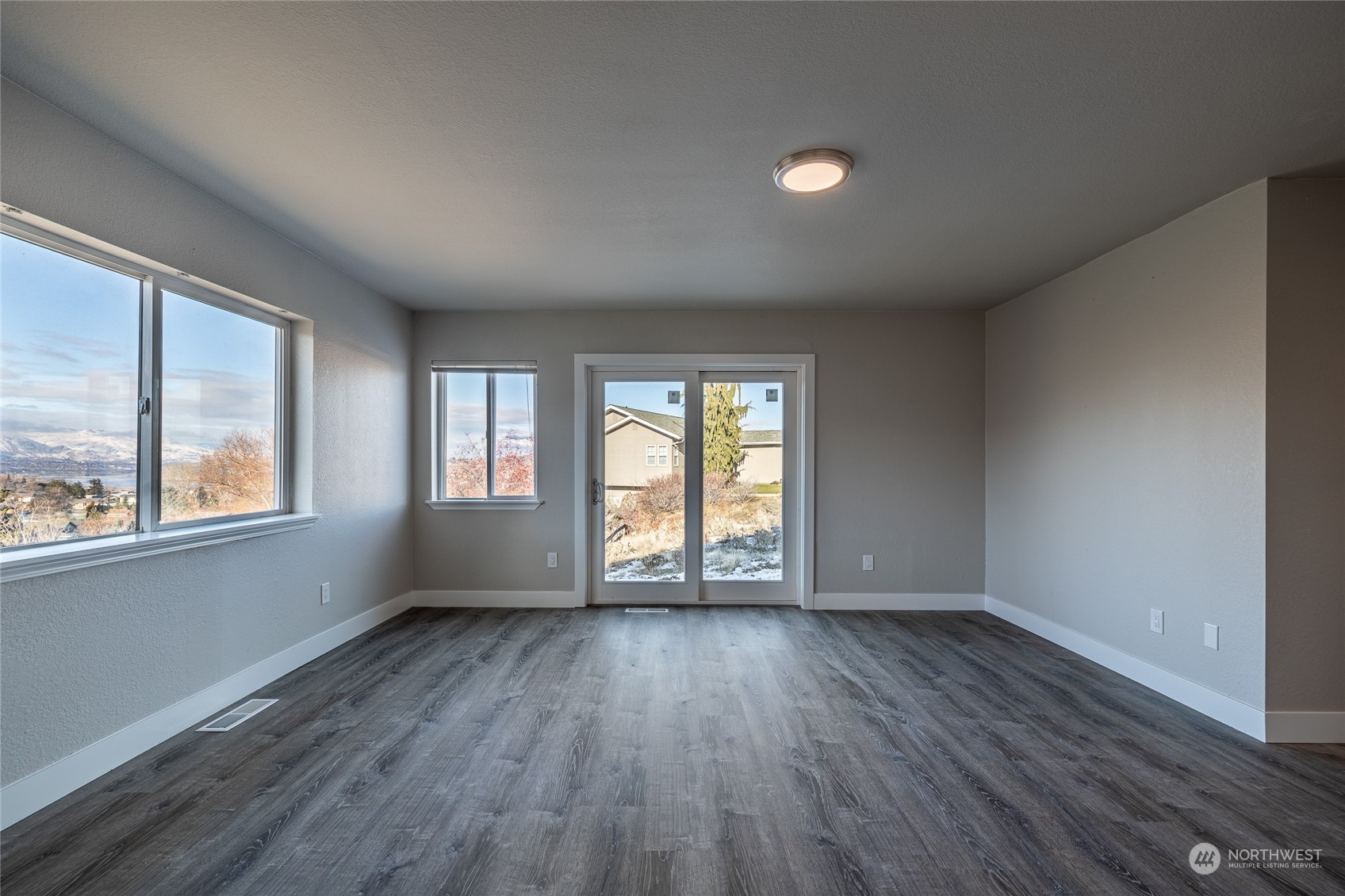 3125 Conarty Road Malaga, WA 98828 - Photo 22 of 37 an empty room with wooden floor and windows