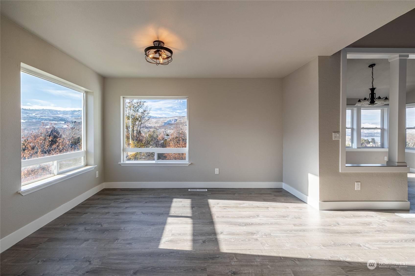 3125 Conarty Road Malaga, WA 98828 - Photo 8 of 37 a view of an empty room with a window and wooden floor
