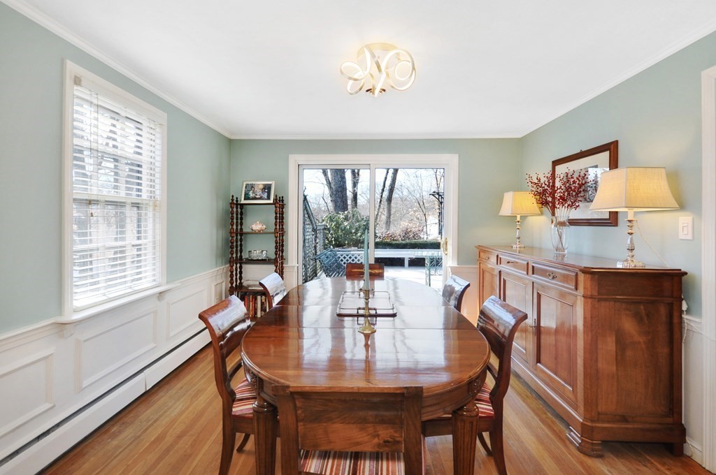 51 Melvin Road Arlington, MA 02474 - Photo 19 of 42 a dining room with furniture a window and wooden floor