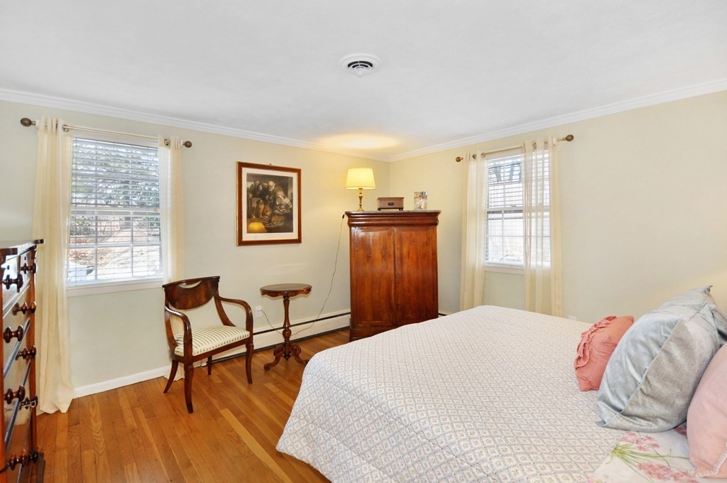 51 Melvin Road Arlington, MA 02474 - Photo 28 of 42 a bedroom with a bed and a dresser next to a window