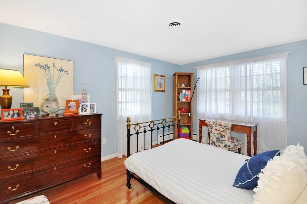 51 Melvin Road Arlington, MA 02474 - Photo 33 of 42 a bedroom with a bed and a table in it