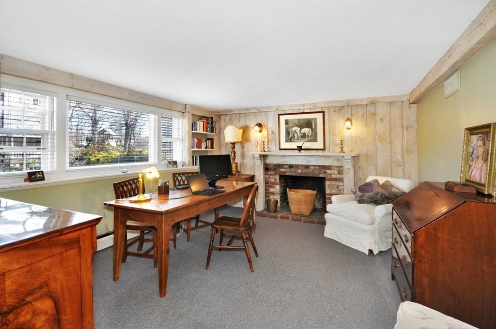 51 Melvin Road Arlington, MA 02474 - Photo 6 of 42 a living room with furniture a fireplace and large windows