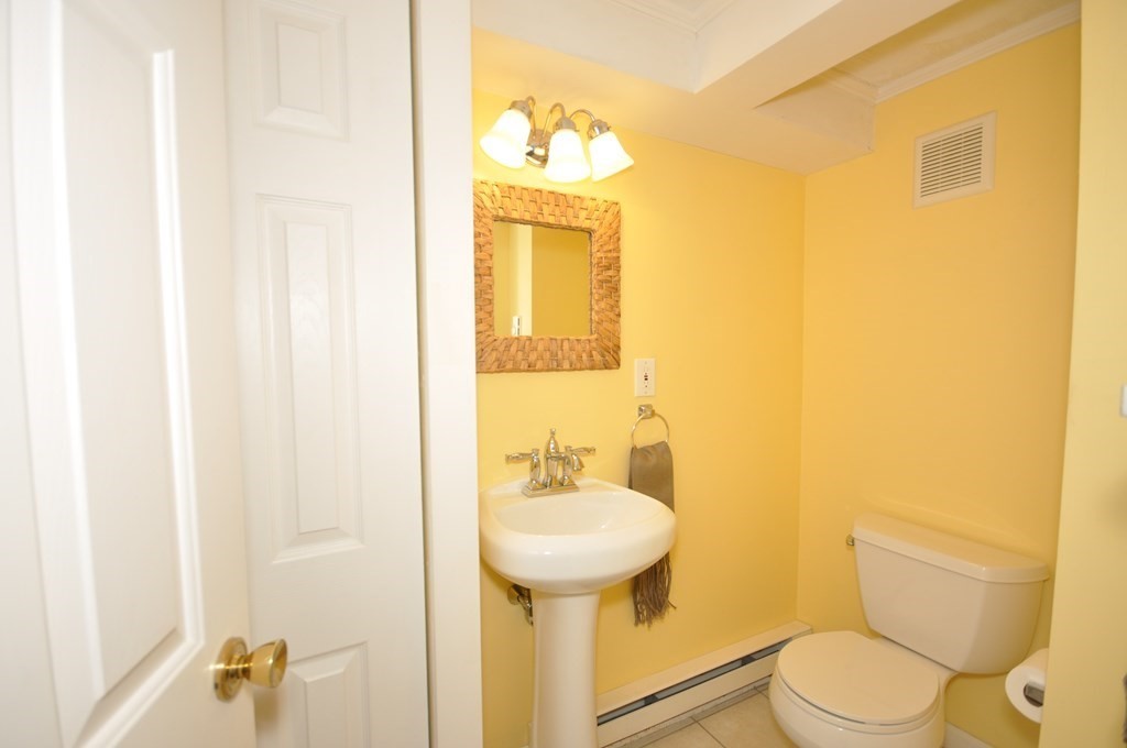 51 Melvin Road Arlington, MA 02474 - Photo 9 of 42 a bathroom with a toilet sink and mirror