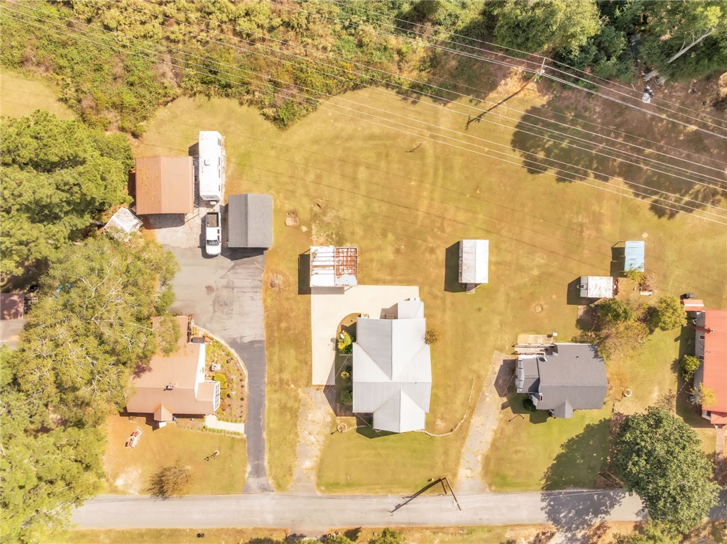 121 Ellison Street Belton, SC 29627 - Photo 24 of 30 An aerial perspective reveals a private yard with multiple structures and a clear landscape.
