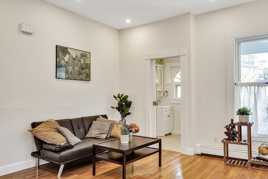12 Rindge Avenue, Unit 2 Cambridge, MA 02140 - Photo 11 of 25 a living room with furniture and wooden floor