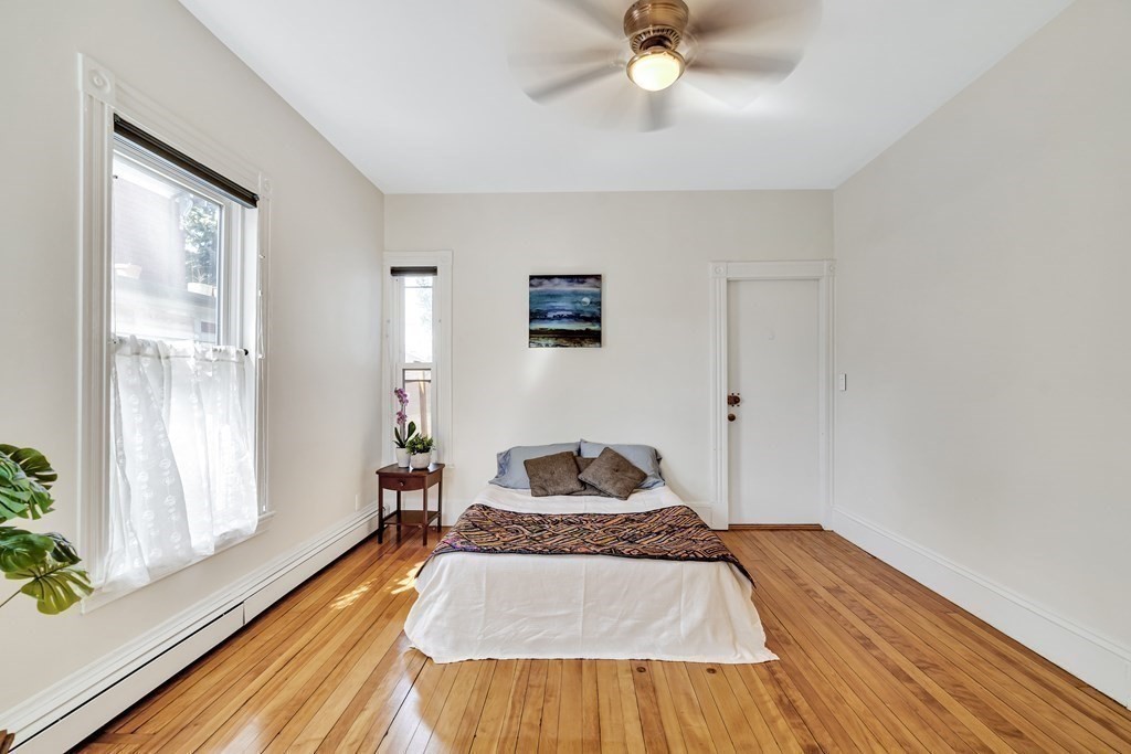 12 Rindge Avenue, Unit 2 Cambridge, MA 02140 - Photo 13 of 25 a bedroom with a bed and wooden floor