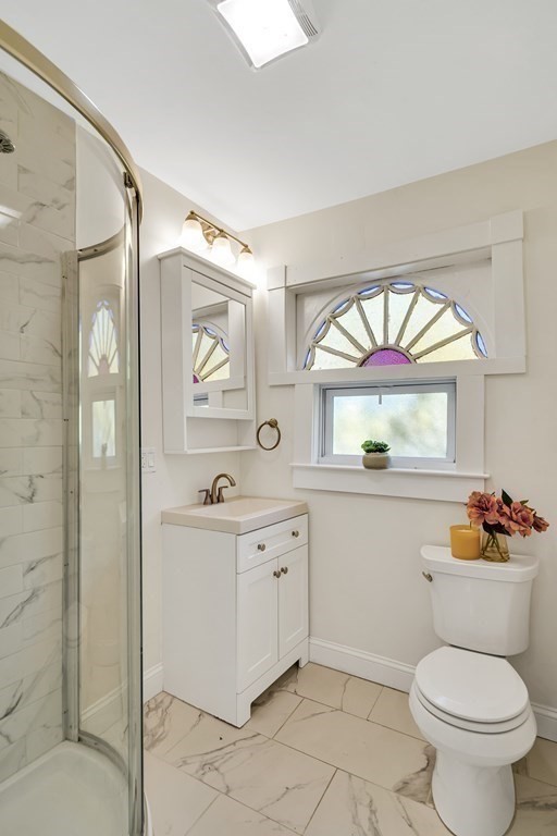 12 Rindge Avenue, Unit 2 Cambridge, MA 02140 - Photo 17 of 25 a bathroom with a toilet a sink and a mirror