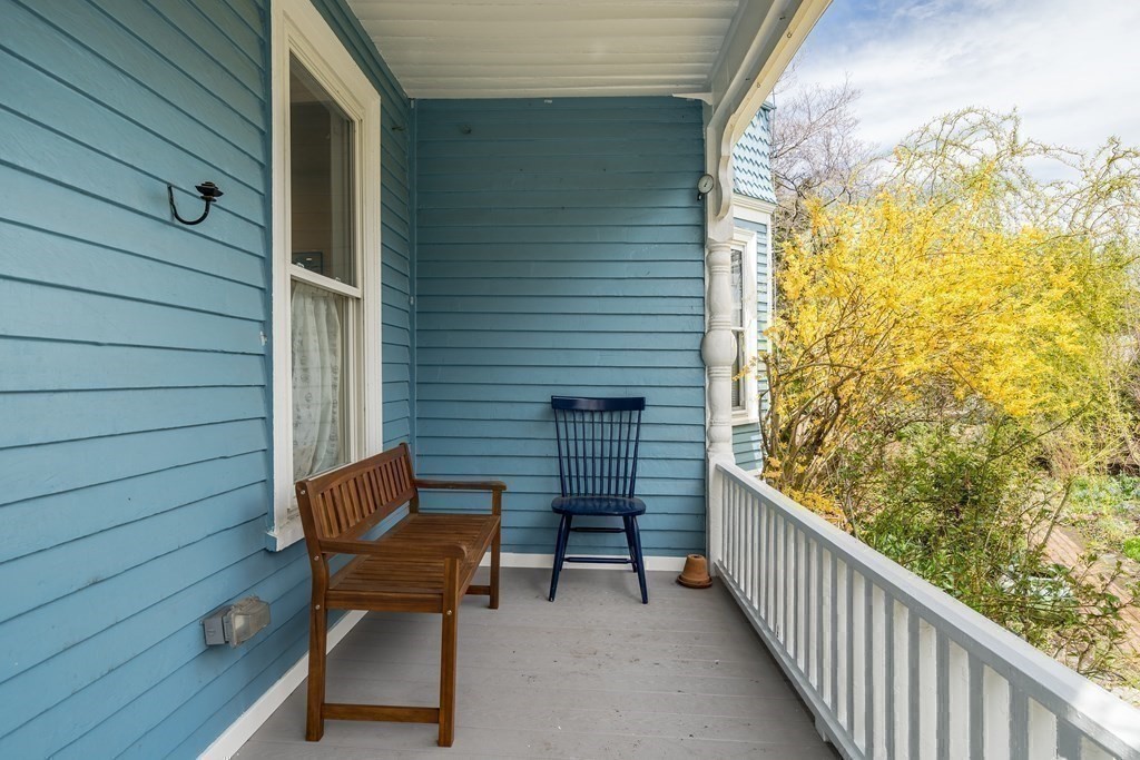 12 Rindge Avenue, Unit 2 Cambridge, MA 02140 - Photo 19 of 25 a view of a balcony with chair and wooden fence