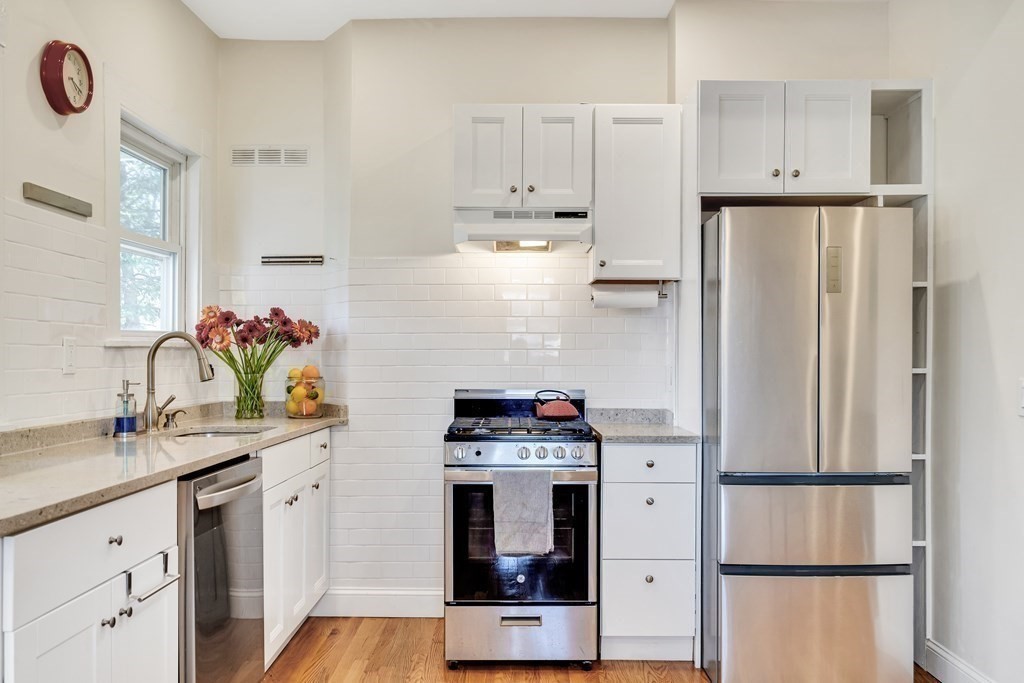 12 Rindge Avenue, Unit 2 Cambridge, MA 02140 - Photo 3 of 25 a kitchen with stainless steel appliances a refrigerator sink and cabinets