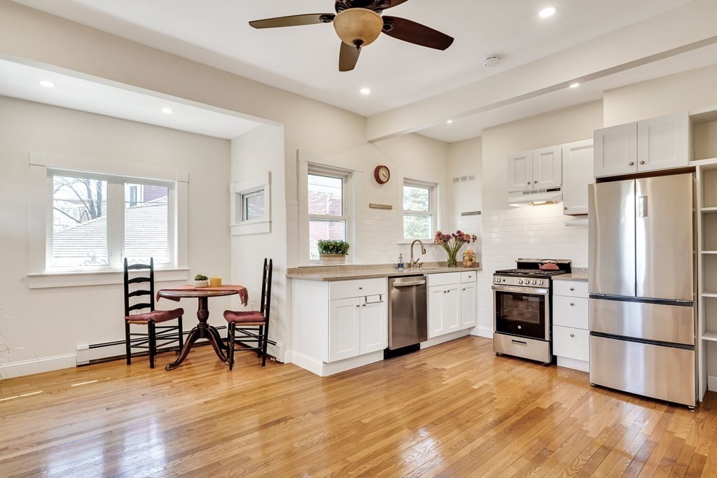 12 Rindge Avenue, Unit 2 Cambridge, MA 02140 - Photo 5 of 25 a kitchen with a refrigerator cabinets and wooden floor